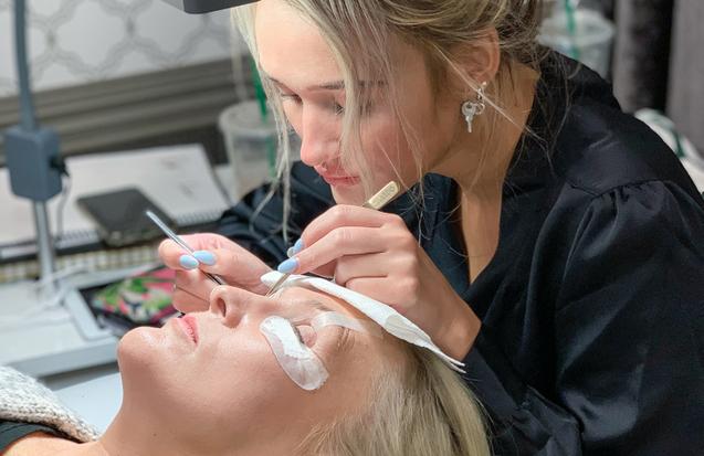 A woman getting her eyelashes done in The Lash Lounge franchise.
